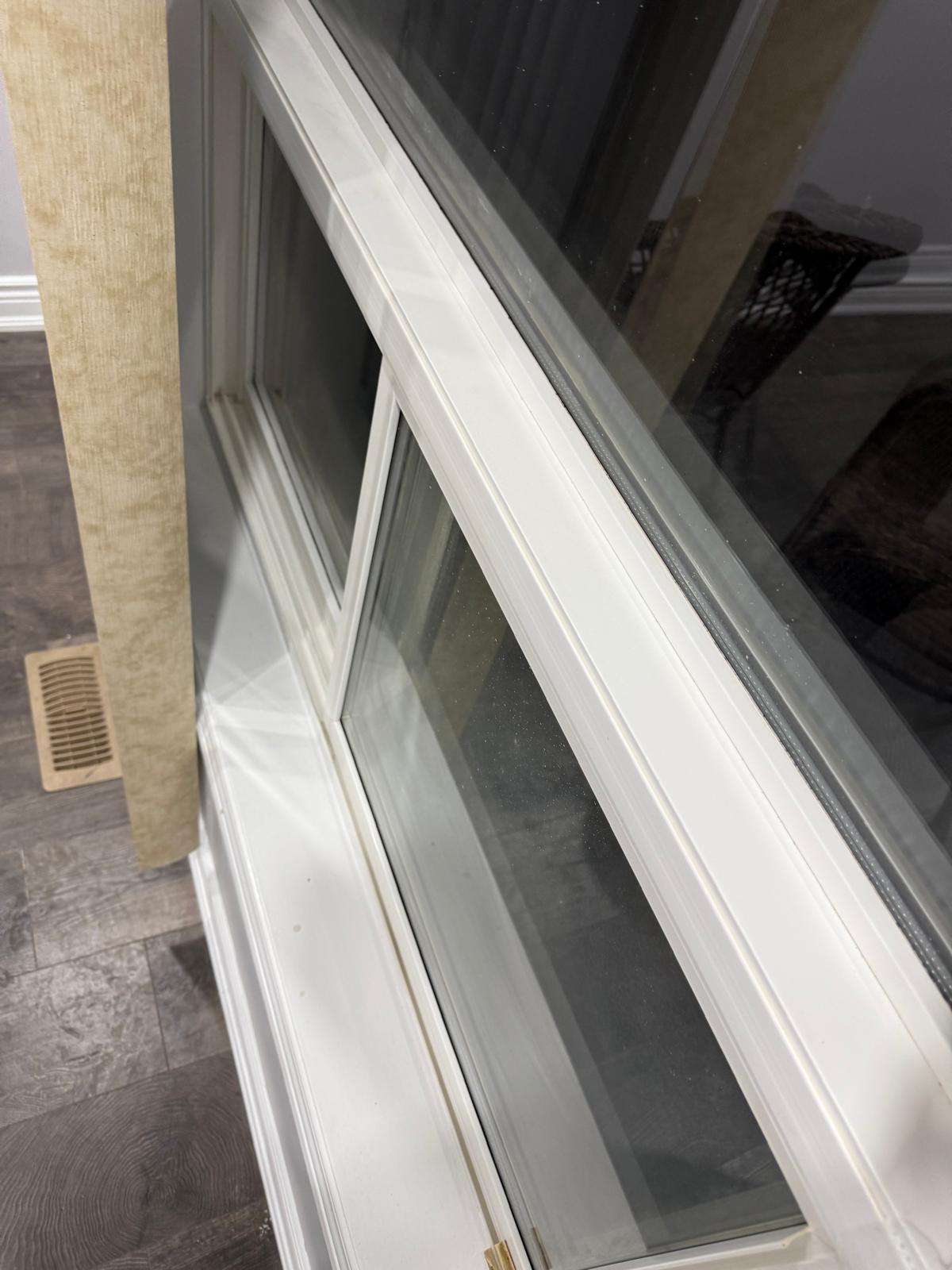 after cleaneing the Window with white frame and reflective glass on a tiled floor.