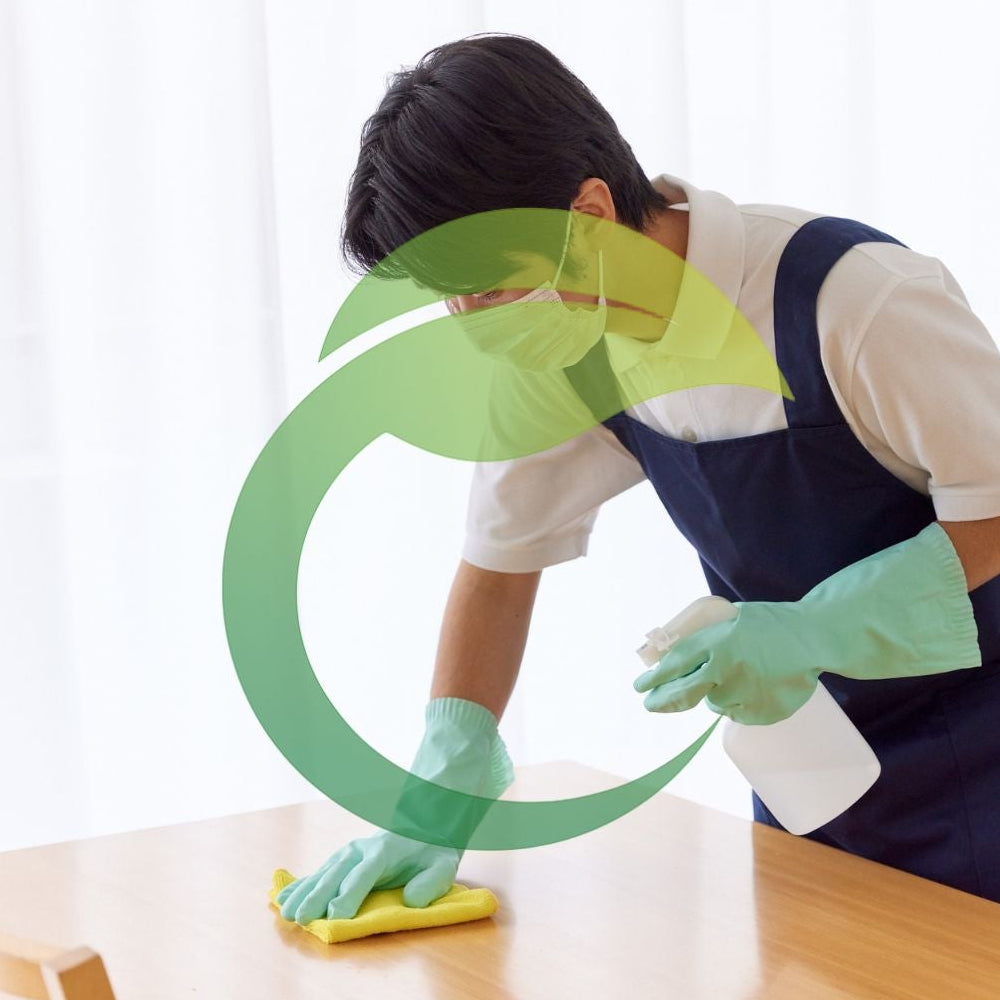 Person cleaning a surface with a green cleaning symbol overlay