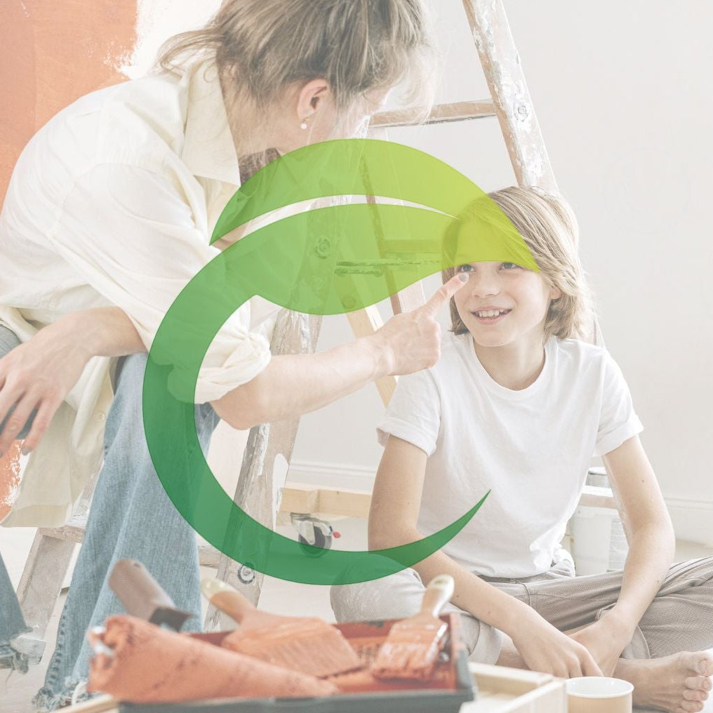 Post-renovation cleaning underway while mother and child sit on the floor.