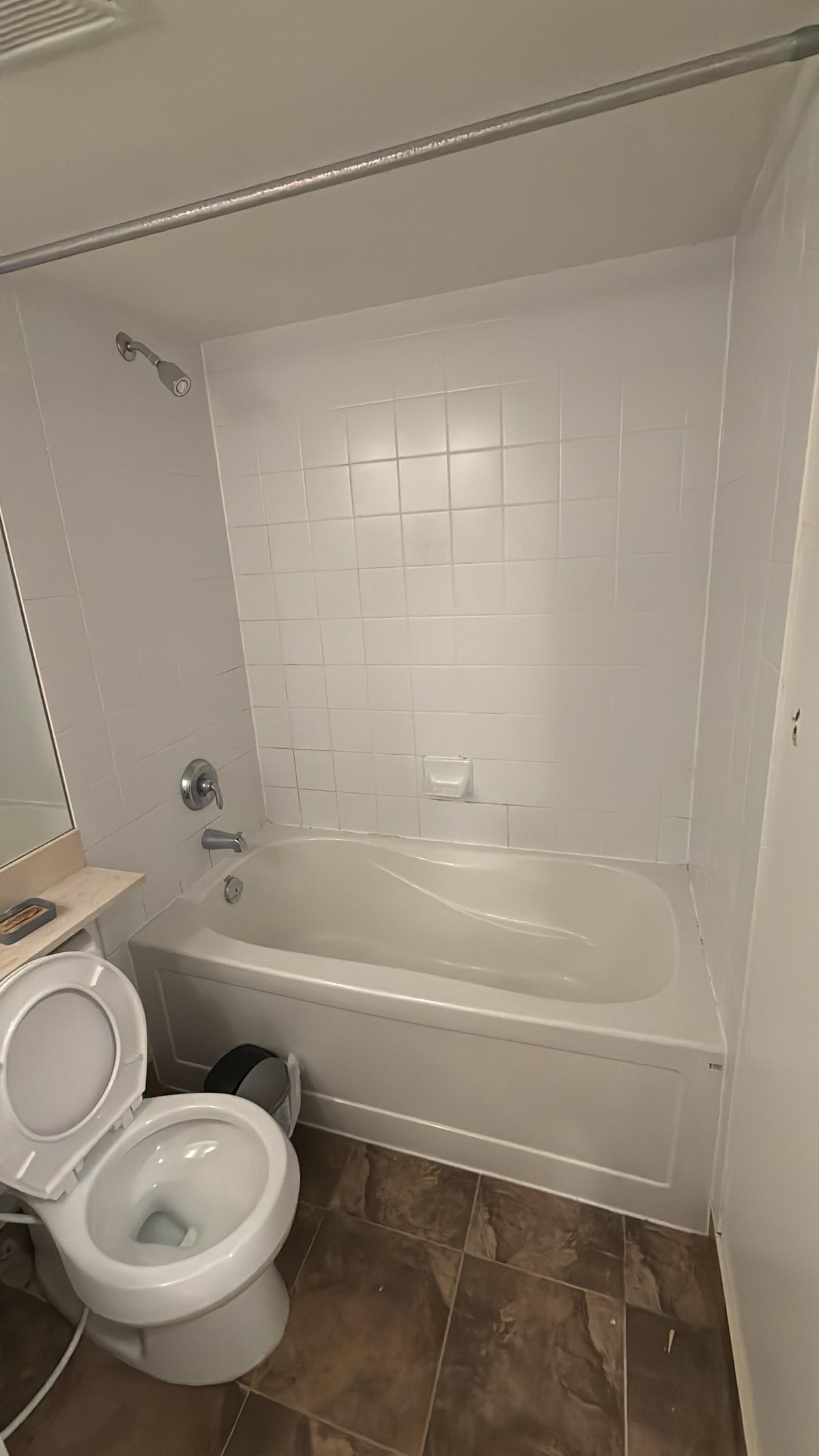 Bathroom with a bathtub and toilet after deep cleaned