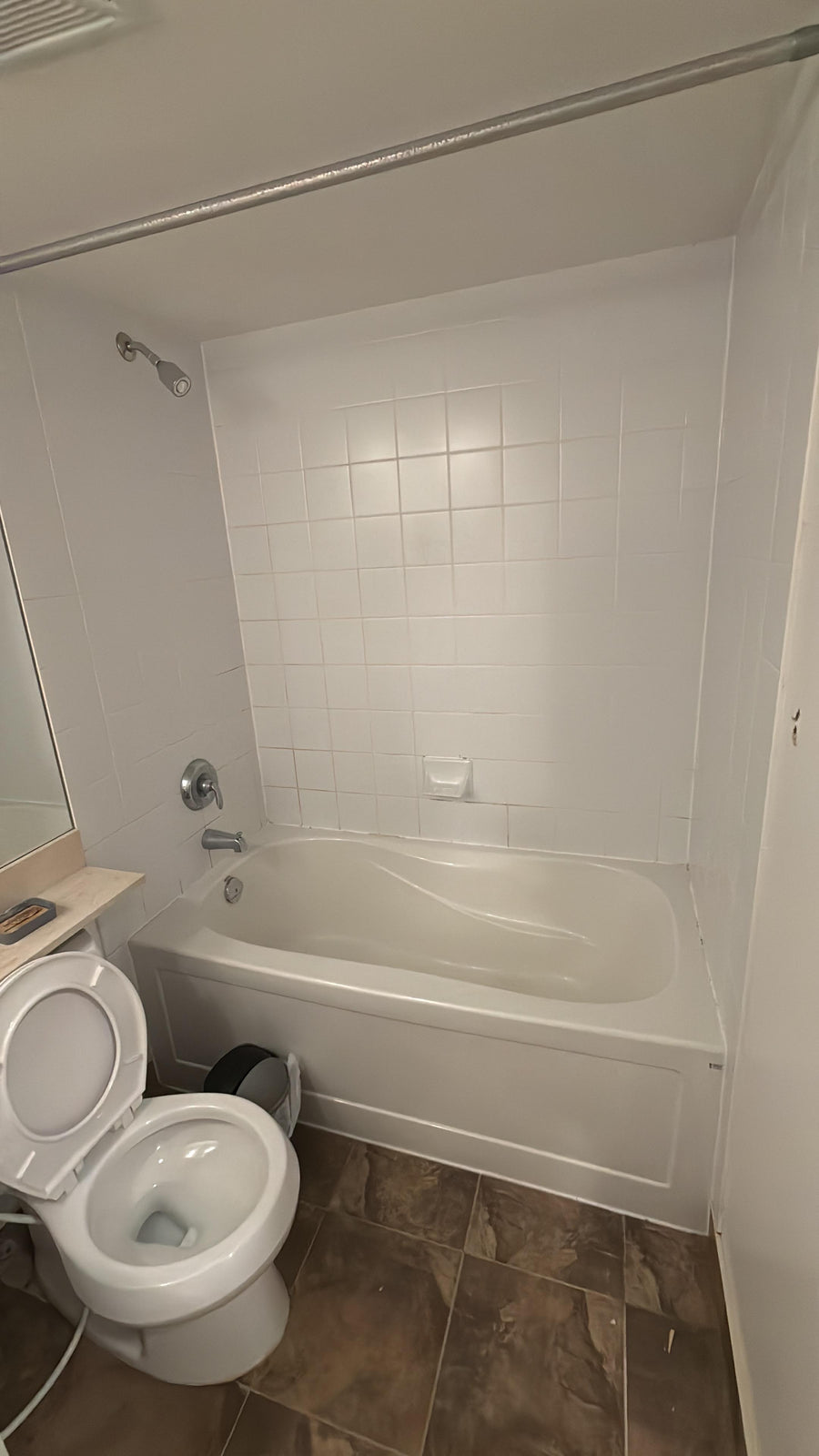 Bathroom with a bathtub and toilet after deep cleaned